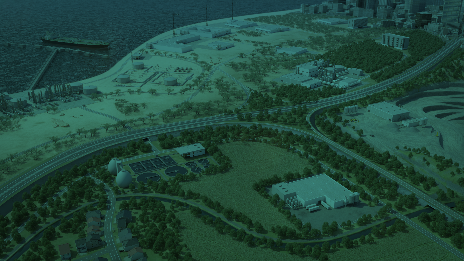 Aerial view of an industrial area near water, featuring facilities, green spaces, and a roadway with residential areas.